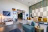 Modern apartment community space with seating area and a reception desk.