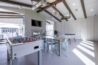 Apartment community space with a foosball table, dining table, fireplace, and TV.